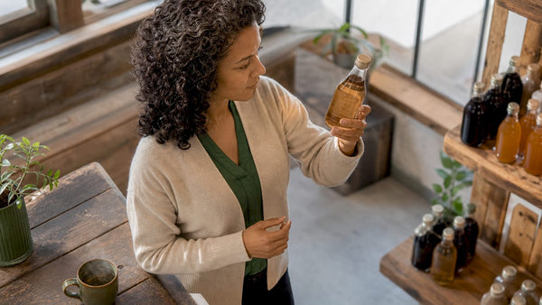 Shopper examining eco-label on beverage bottle