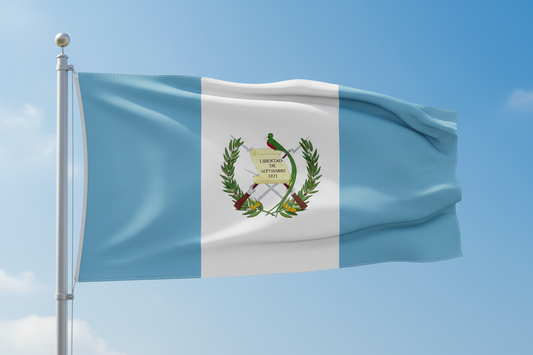 Guatemala flag waving on pole against blue sky for Guatemala medium roast coffee branding