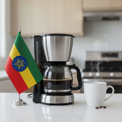 lifestyle picture with a coffee maker on a kitchen counter with a half-filled coffee pot with the Ethiopia flag on one side and a cup of brewed coffee on the other side