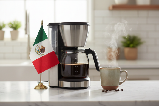 lifestyle picture with a coffee maker on a kitchen counter with a half-filled coffee pot with the Mexico flag on one side and a cup of brewed coffee on the other side