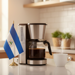 lifestyle picture with a coffee maker on a kitchen counter with a half-filled coffee pot with the Nicaragua flag on one side and a cup of brewed coffee on the other side