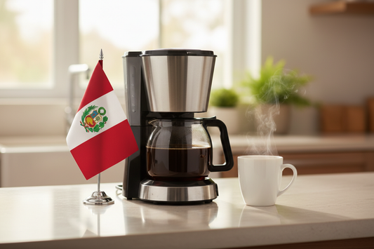 lifestyle picture with a coffee maker on a kitchen counter with a half-filled coffee pot with the Peru flag the left side and a cup of brewed coffee on the other side
